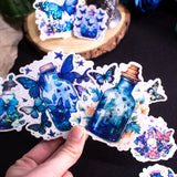 Butterfly Potions Handmade Holographic Vinyl Sticker Set of 8, perfect magical witchy bullet journal gift. In this set, you'll discover 8 potions, each infused with delicate butterfly elements, casting a spell of whimsy and magic.