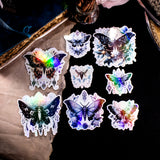 Moths and Butterflies Fantasy Holographic sticker set of 8 pieces, with natural witchy elements. Step into a realm of enchantment with our meticulously handcrafted set of 8 stickers, featuring ethereal moths and butterflies in a dark fantasy style.