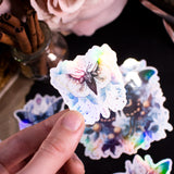 Moths and Butterflies Fantasy Holographic sticker set of 8 pieces, with natural witchy elements. Step into a realm of enchantment with our meticulously handcrafted set of 8 stickers, featuring ethereal moths and butterflies in a dark fantasy style.