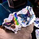 Moths and Butterflies Fantasy Holographic sticker set of 8 pieces, with natural witchy elements. Step into a realm of enchantment with our meticulously handcrafted set of 8 stickers, featuring ethereal moths and butterflies in a dark fantasy style.