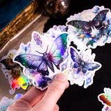 Moths and Butterflies Fantasy Holographic sticker set of 8 pieces, with natural witchy elements. Step into a realm of enchantment with our meticulously handcrafted set of 8 stickers, featuring ethereal moths and butterflies in a dark fantasy style.