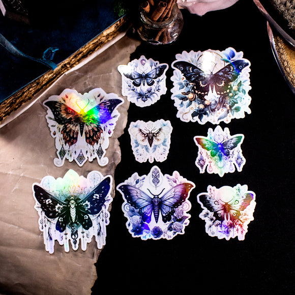 Moths and Butterflies Fantasy Holographic sticker set of 8 pieces, with natural witchy elements. Step into a realm of enchantment with our meticulously handcrafted set of 8 stickers, featuring ethereal moths and butterflies in a dark fantasy style. 