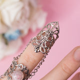 Angel Claw ring with adjustable metallic base and pink stones 1