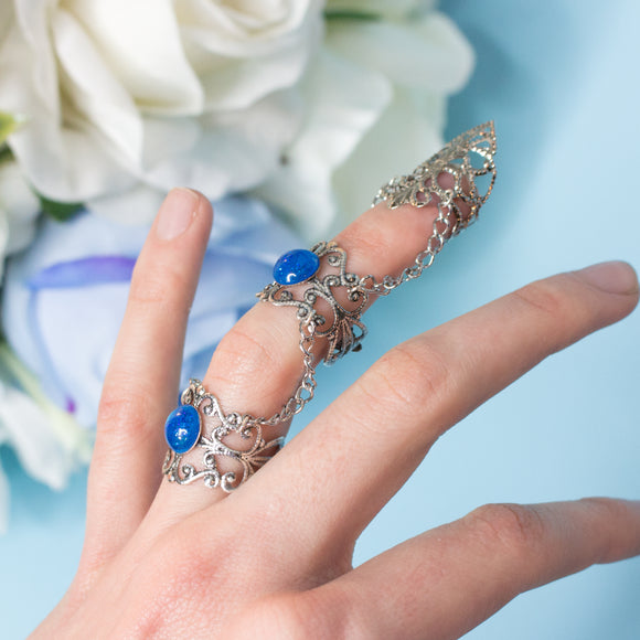 Siren Claw ring with adjustable metallic base and blue stones