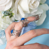 Siren Claw ring with adjustable metallic base and blue stones