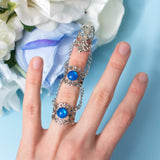 Siren Claw ring with adjustable metallic base and blue stones