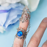 Siren Claw ring with adjustable metallic base and blue stones