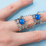 Siren Claw ring with adjustable metallic base and blue stones